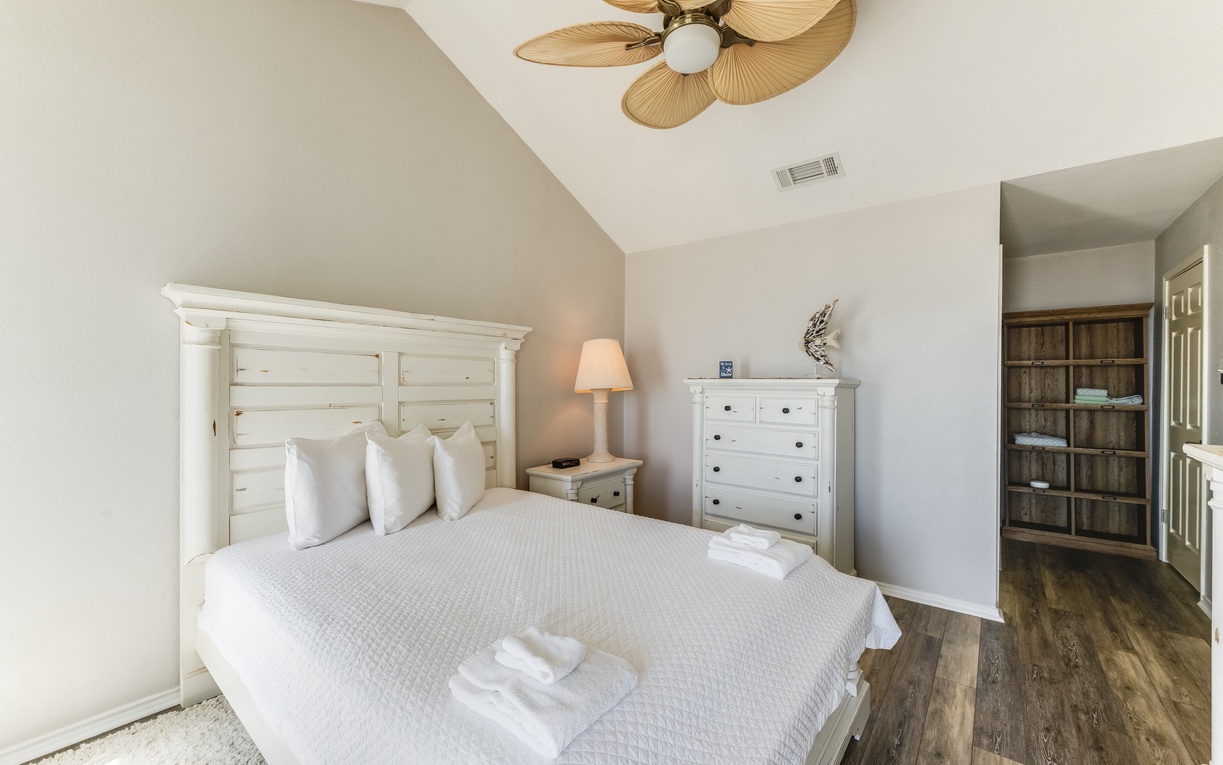 Unwind in your peaceful bedroom with rustic charm, crisp linens, and a soothing ceiling fan for ultimate comfort.