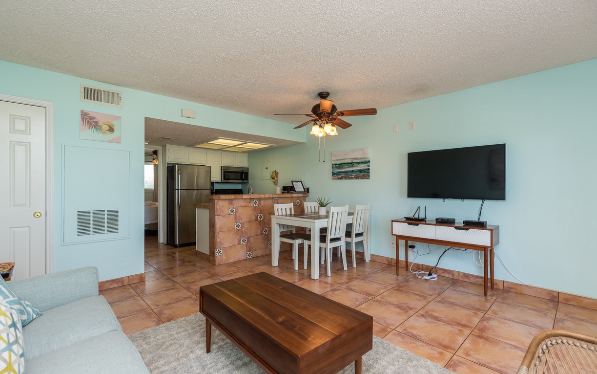 Relax in your bright, coastal-inspired living space where soft mint walls and warm tile floors create a soothing retreat for your beach getaway.