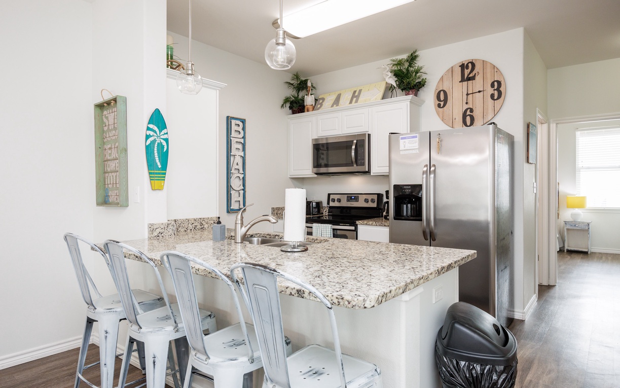Your coastal-themed kitchen offers granite counters, stainless appliances, and beach decor for memorable meal prep together.