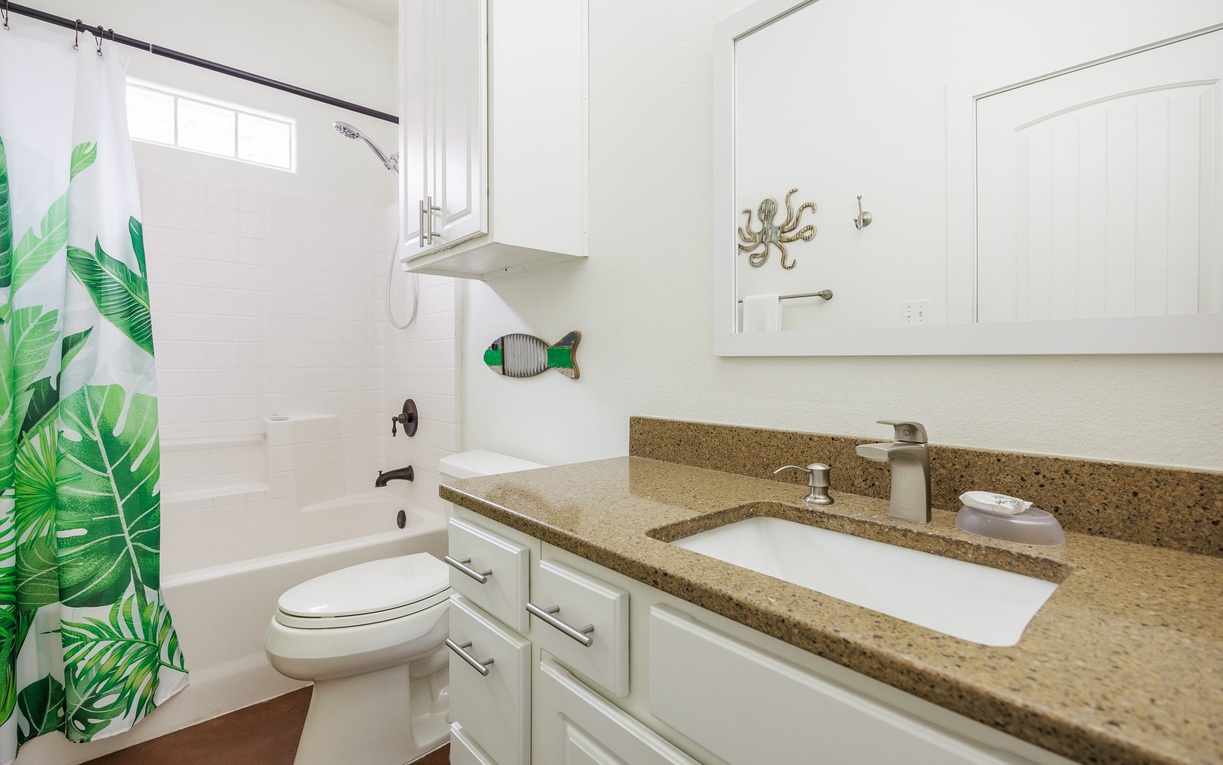 Refresh in your bright bathroom with tropical-inspired touches, featuring a spacious vanity and relaxing tub-shower combo.