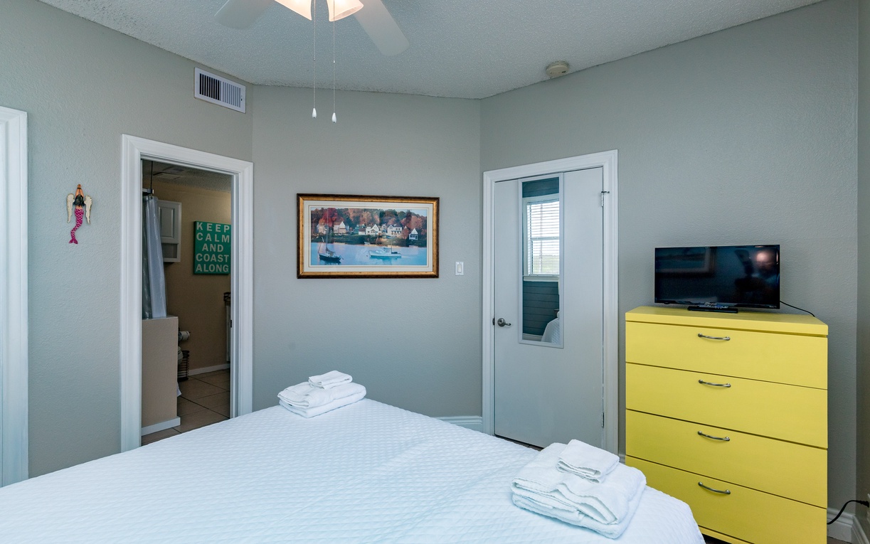 Relax in your peaceful bedroom with cozy coastal charm, fresh towels, and entertainment at your fingertips.
