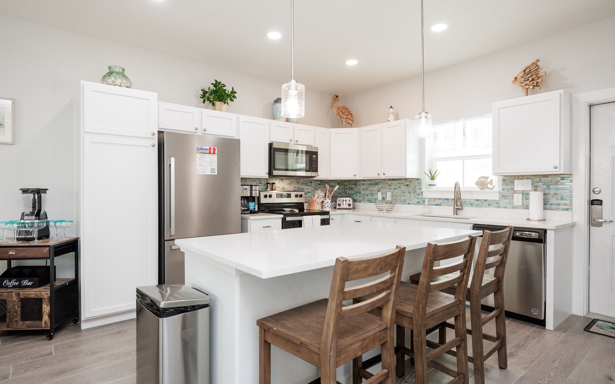 Your fully equipped kitchen features modern appliances, spacious countertops, and a breakfast bar where you can enjoy morning coffee together.