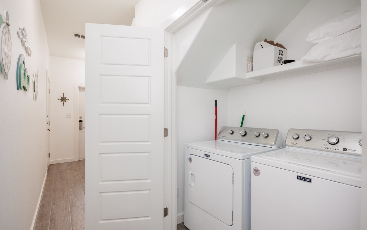 Your own private laundry nook makes travel effortless—full-size washer and dryer with thoughtful shelving for supplies.