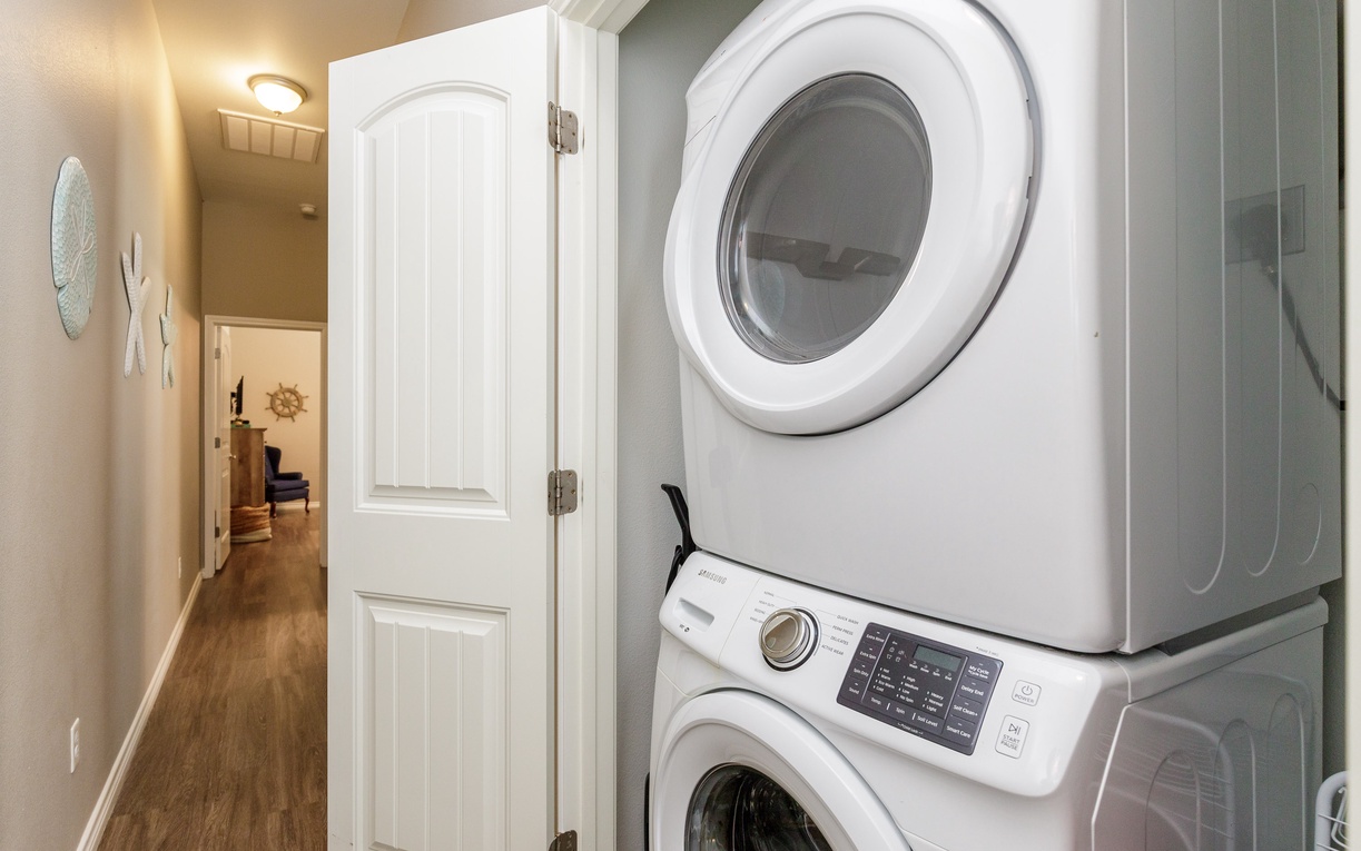 Your private stacked washer and dryer keeps your wardrobe fresh throughout your stay, tucked conveniently in your hallway.