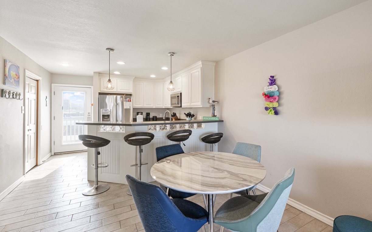 Your open-plan kitchen flows seamlessly into a bright dining space, perfect for morning coffee or evening meals with loved ones.
