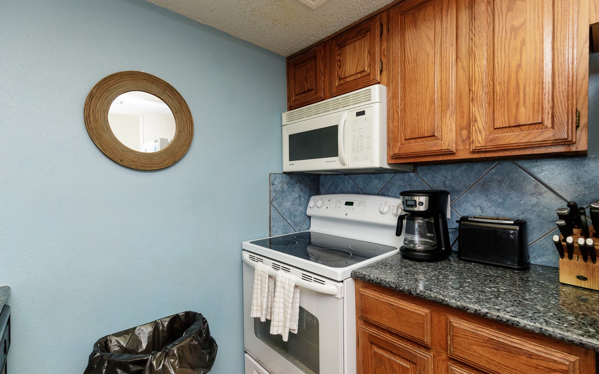Your fully equipped kitchen features granite counters, rich wood cabinets, and everything needed for home-cooked meals during your stay.
