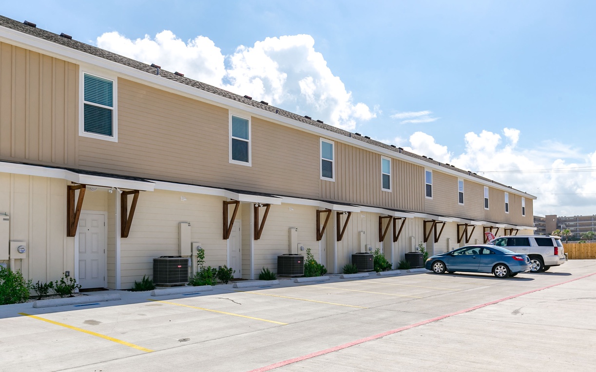 Modern townhouse-style rental building featuring dedicated parking spaces and convenient ground-floor access for easy arrival.