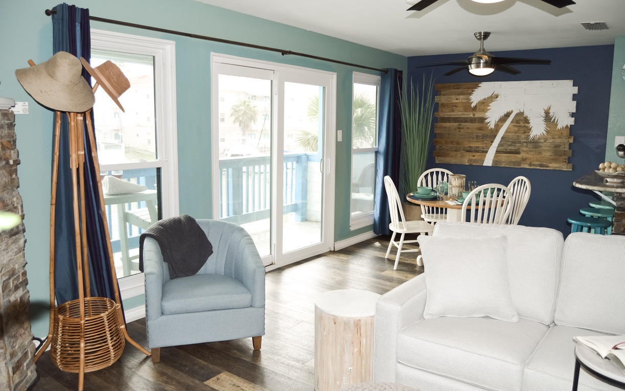 Relax in your coastal retreat with beach-themed decor, comfortable seating, and sliding doors to your private balcony.