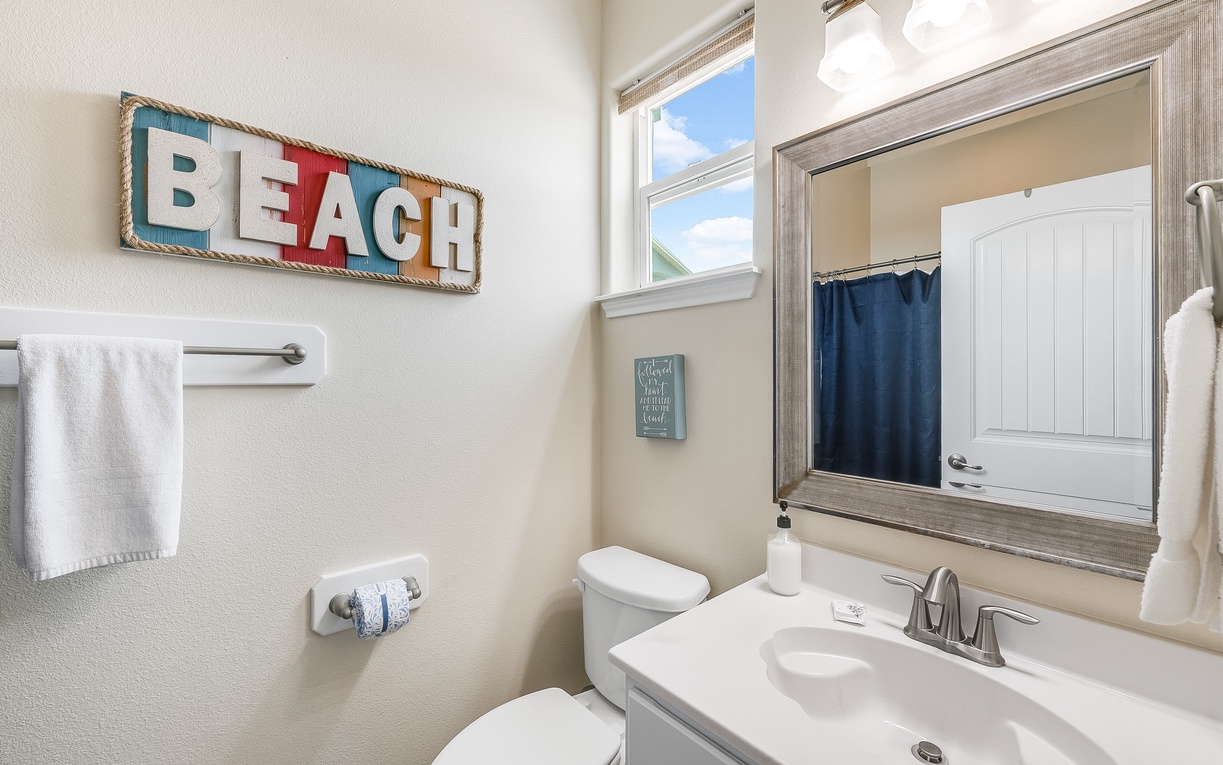 Refresh in your charming beach-themed bathroom, complete with coastal décor and fresh towels for your comfort.