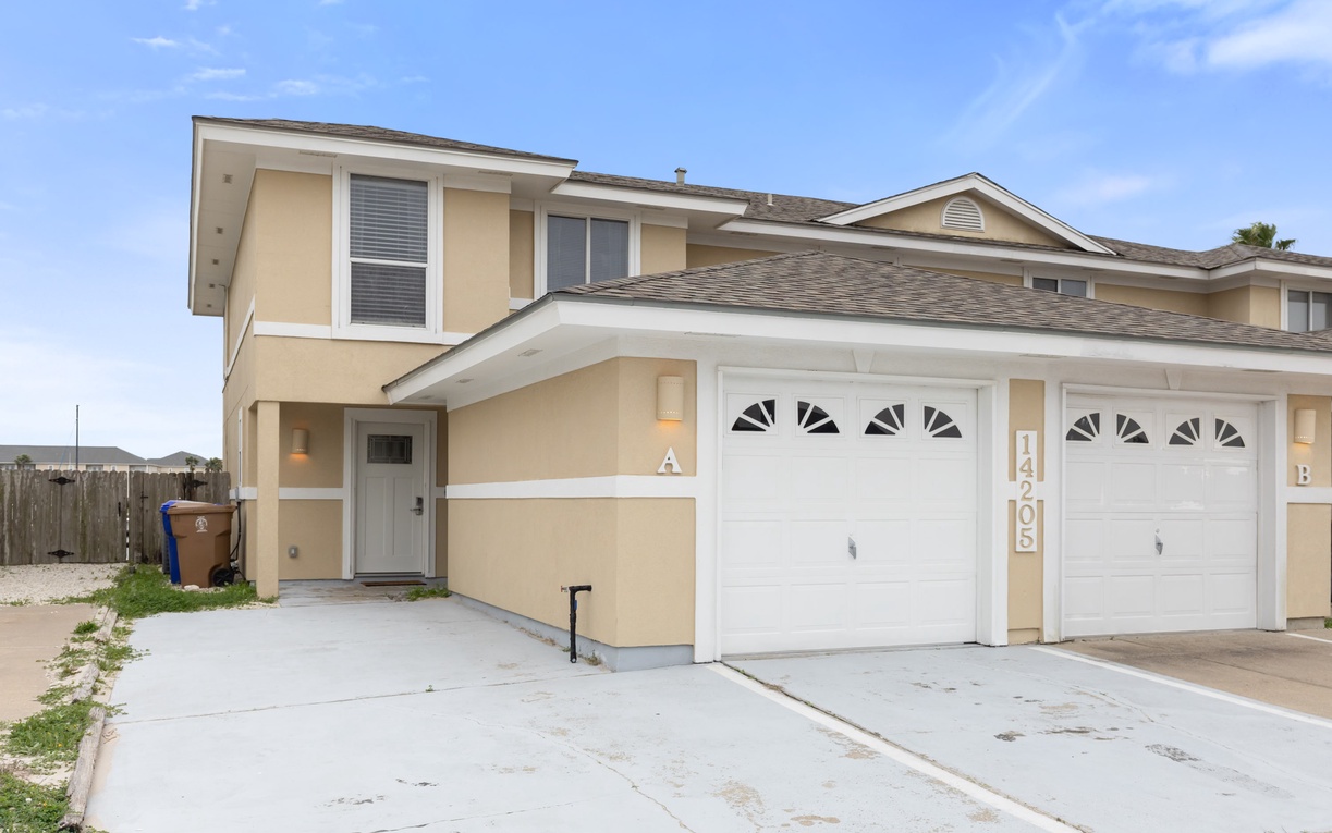 Modern two-story townhome with convenient driveway parking for easy arrival and departure.