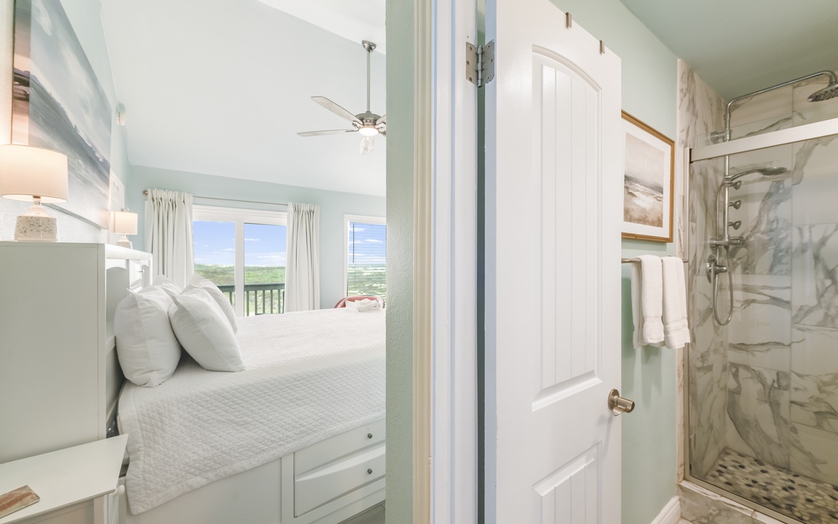 Wake up to natural light and calming coastal breezes in this serene bedroom. With an ensuite bathroom featuring a walk-in shower, you'll enjoy coastal tranquility and modern comfort in one inviting space.