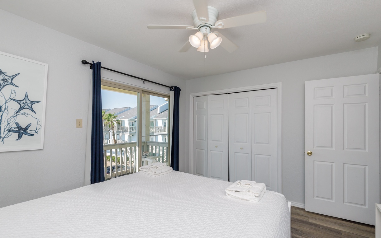 Guest bedroom on the second floor with a queen size bed.