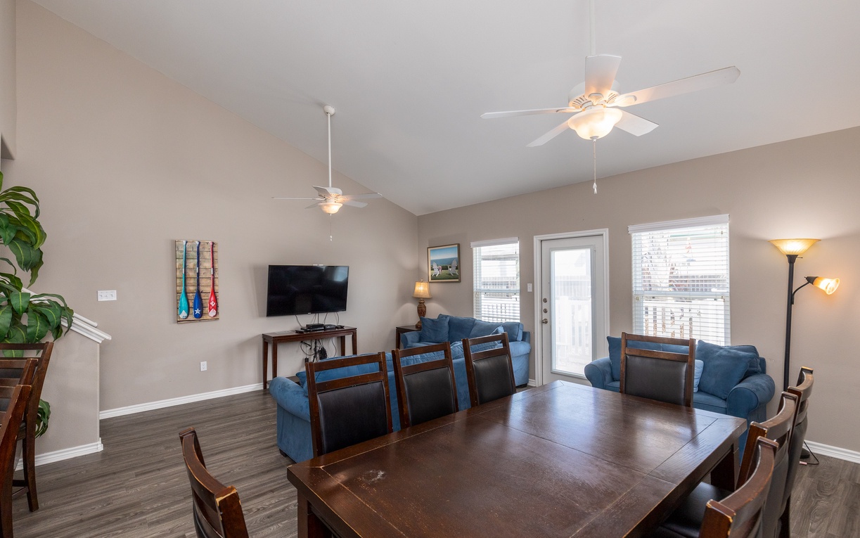 Gather with loved ones in this spacious open living area featuring comfortable seating and natural light from large windows.
