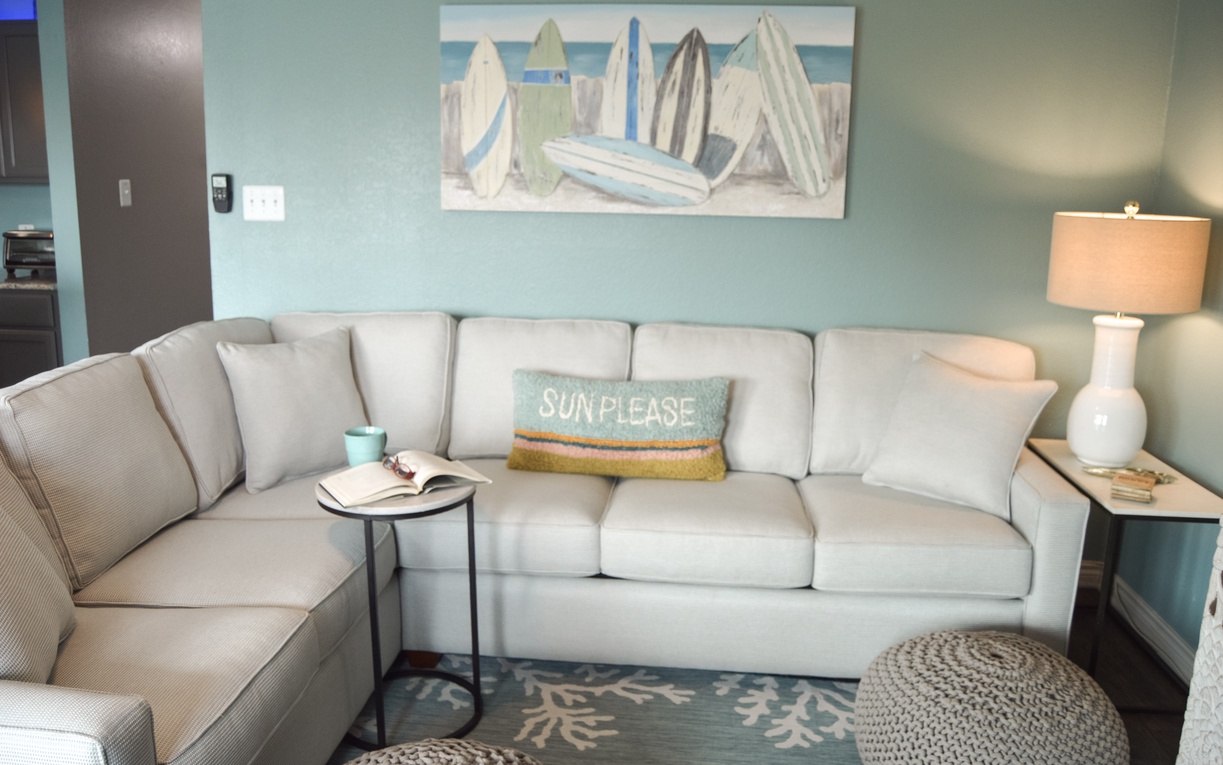 Sink into this cozy sectional where coastal vibes meet comfort - your perfect spot for morning coffee or evening relaxation.