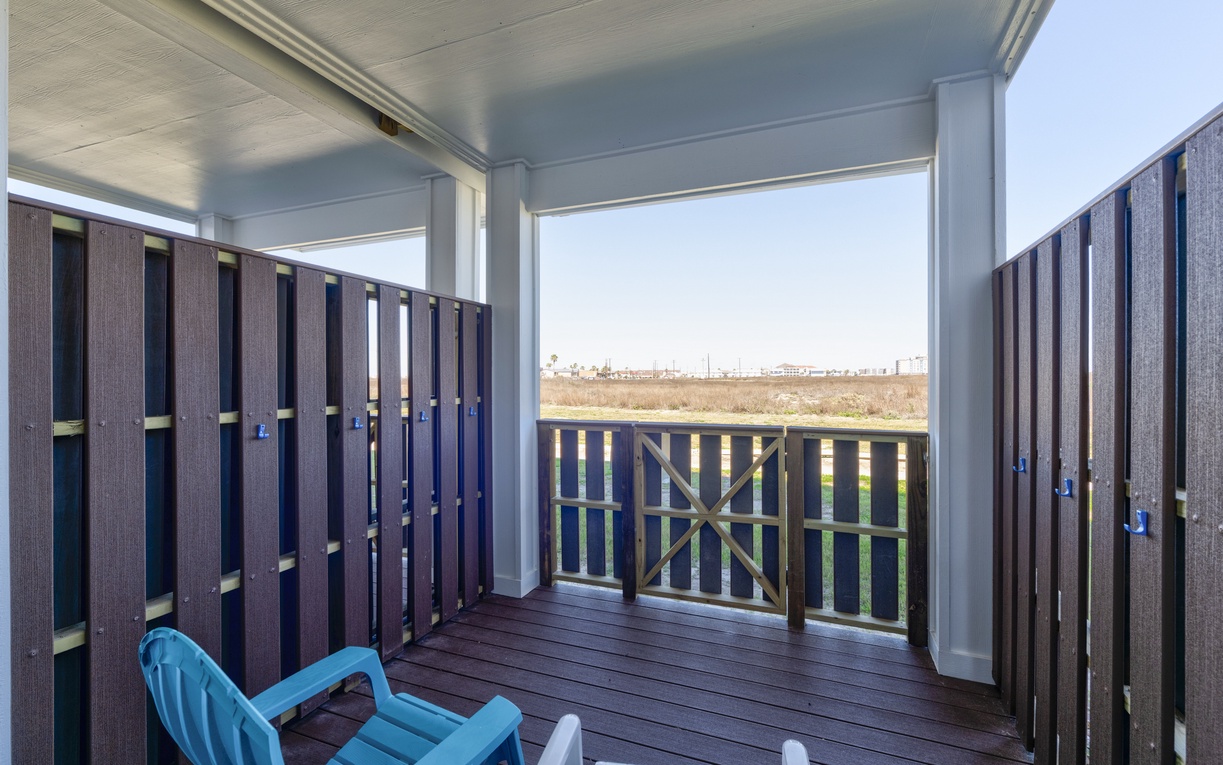 Relax on your private covered balcony with comfortable seating and peaceful views over the natural landscape beyond.
