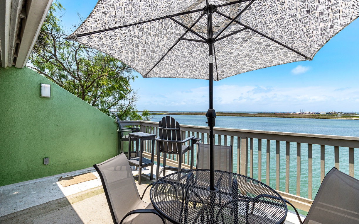 Enjoy your morning coffee on this waterfront balcony, where gentle breezes and stunning water views create the perfect retreat.