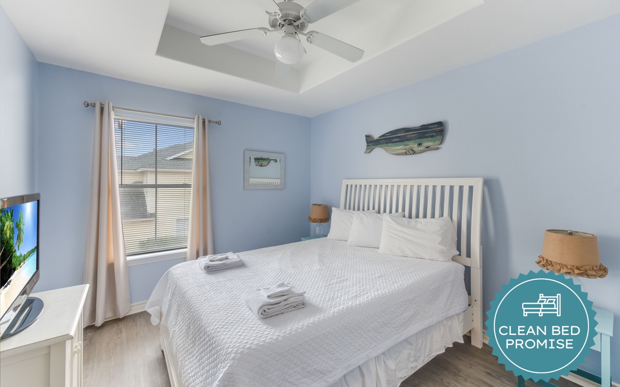 Drift off in this peaceful bedroom with soft blue walls and coastal decor creating your perfect seaside retreat.