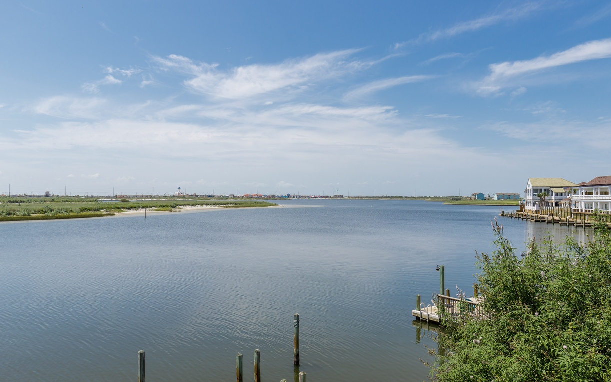 Tranquil waterfront setting with peaceful bay views and charming coastal homes dotting the shoreline.