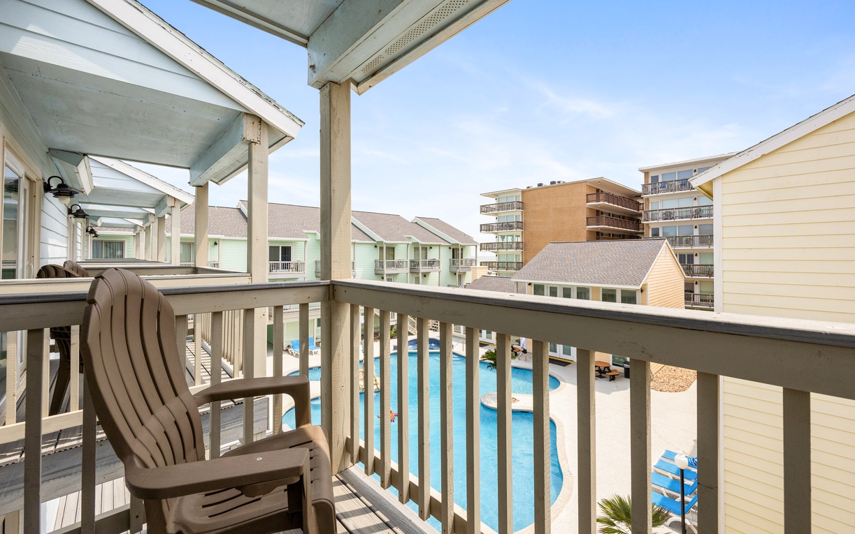Your private balcony overlooks the sparkling pool, perfect for morning coffee or evening relaxation with stunning resort views.