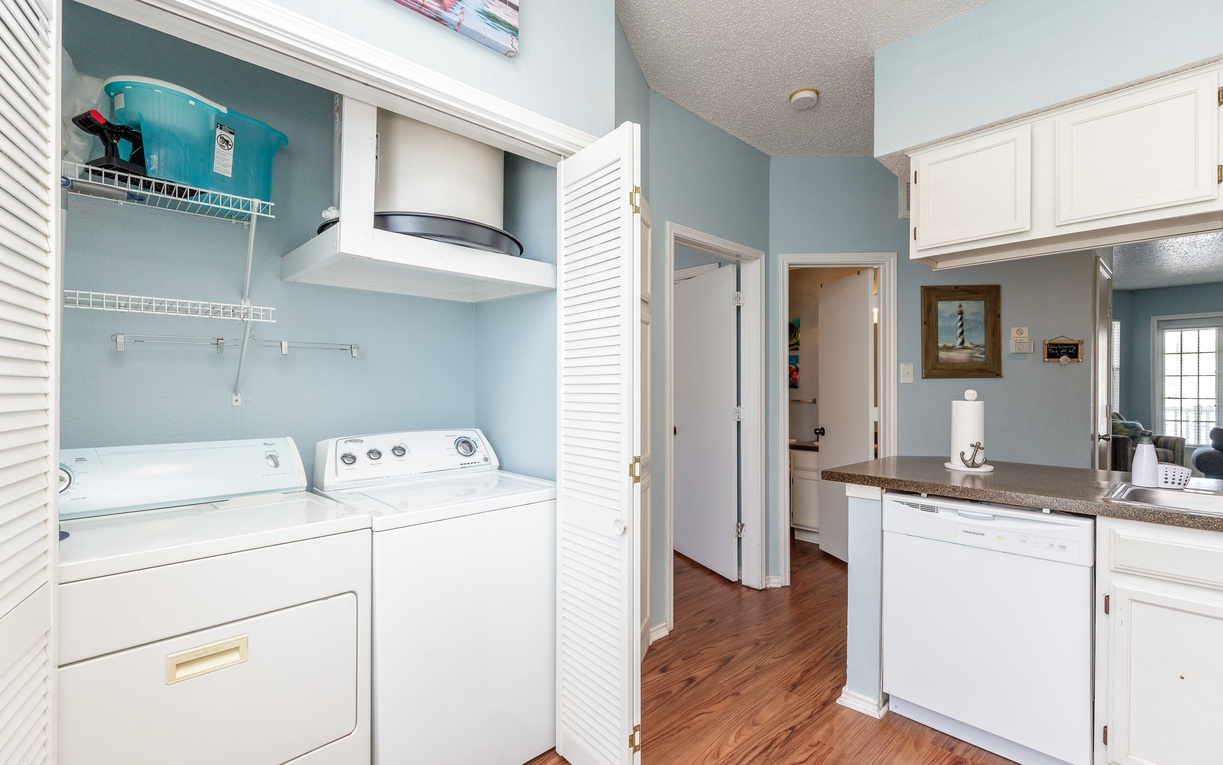 Your dedicated laundry nook keeps vacation essentials fresh with full-size washer and dryer, plus organized storage for beach gear and supplies.