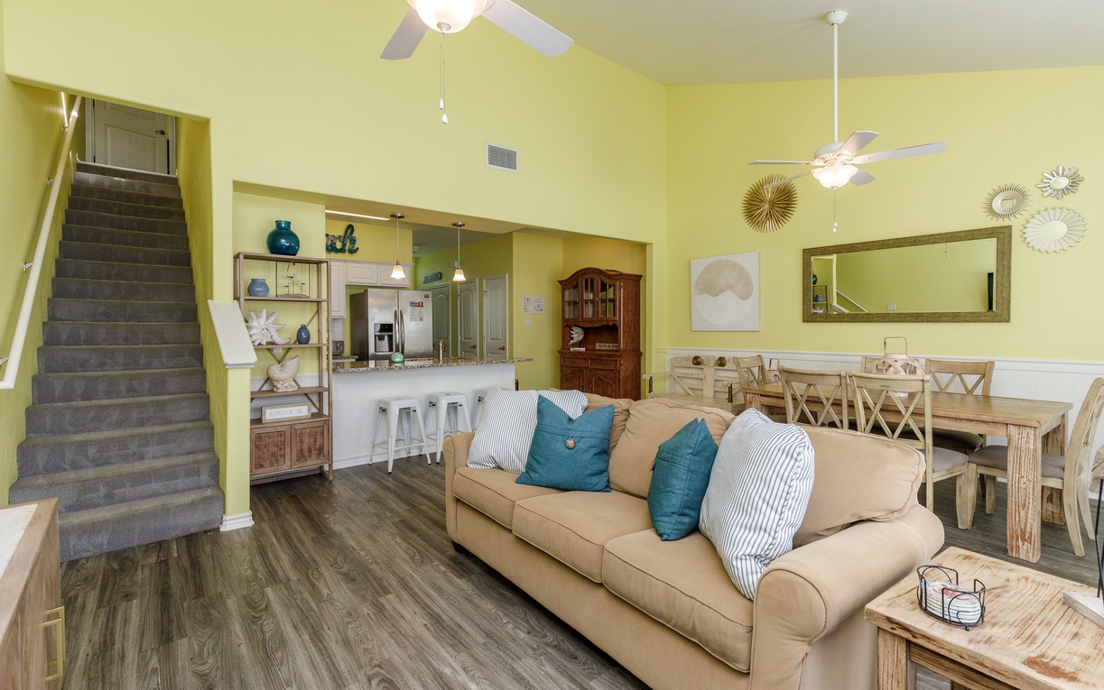 Relax in your open-plan living space with comfortable seating, full kitchen access, and coastal decor that makes you feel right at home.