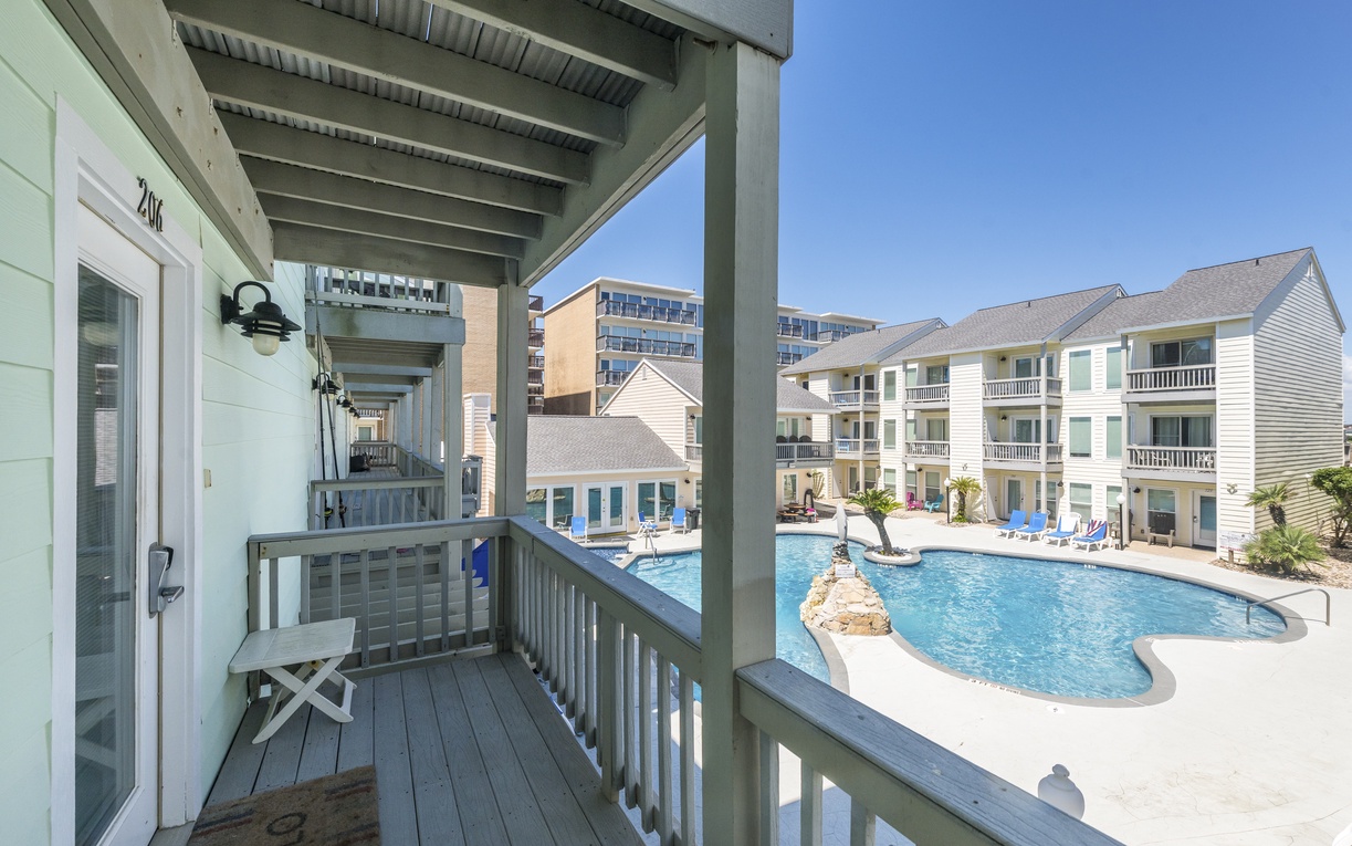 Step onto your private balcony and savor the perfect pool view, where morning coffee tastes better with sparkling water below.