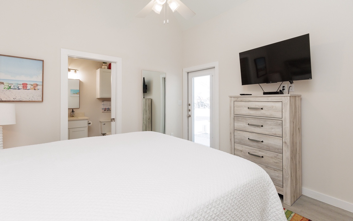 Relax in your bright bedroom with crisp linens, wall-mounted TV, and convenient dresser storage. Your private bathroom awaits just steps away.
