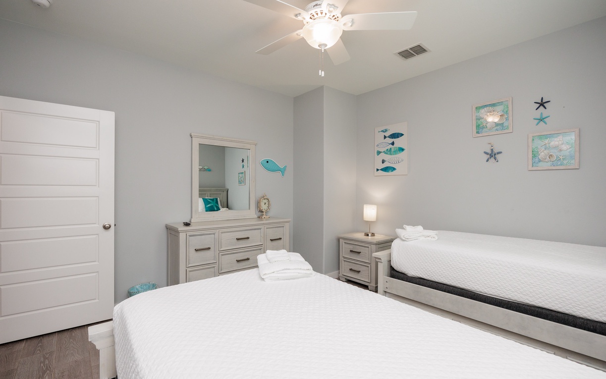 Your coastal-themed bedroom offers 2 twin beds with a twin size trundle bed..
