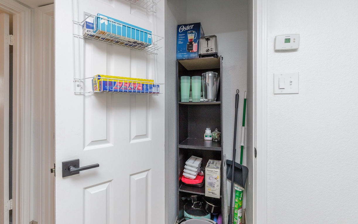 Your organized utility closet keeps essentials tidy, with cleaning supplies and household items perfectly arranged for convenience.