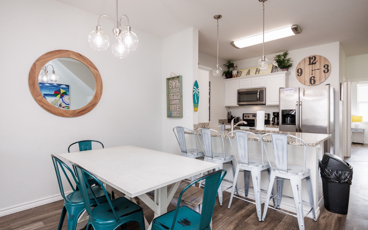 Your bright, open kitchen and dining space features modern appliances and cheerful coastal touches, perfect for sharing meals together.