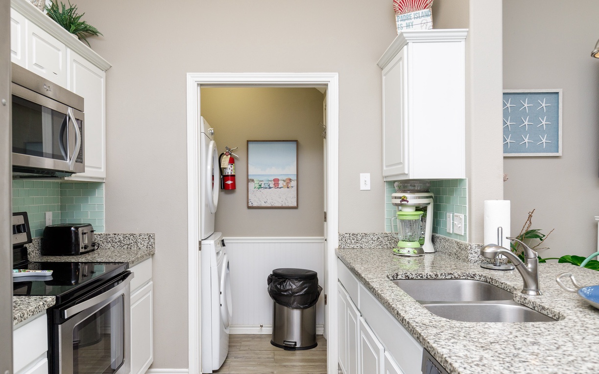 Your fully equipped kitchen features granite counters, stainless appliances, and connecting laundry room for ultimate convenience.