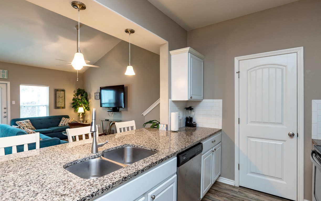 Your modern kitchen features granite counters and stainless steel appliances, opening to a cozy living area where you'll love relaxing after cooking.