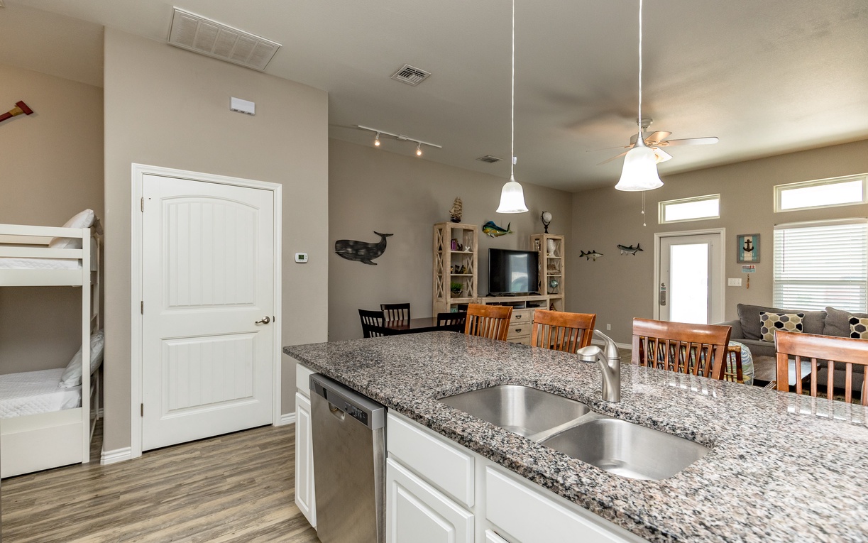 Your open kitchen flows into the dining and living area, perfect for family gatherings with granite countertops and modern appliances.
