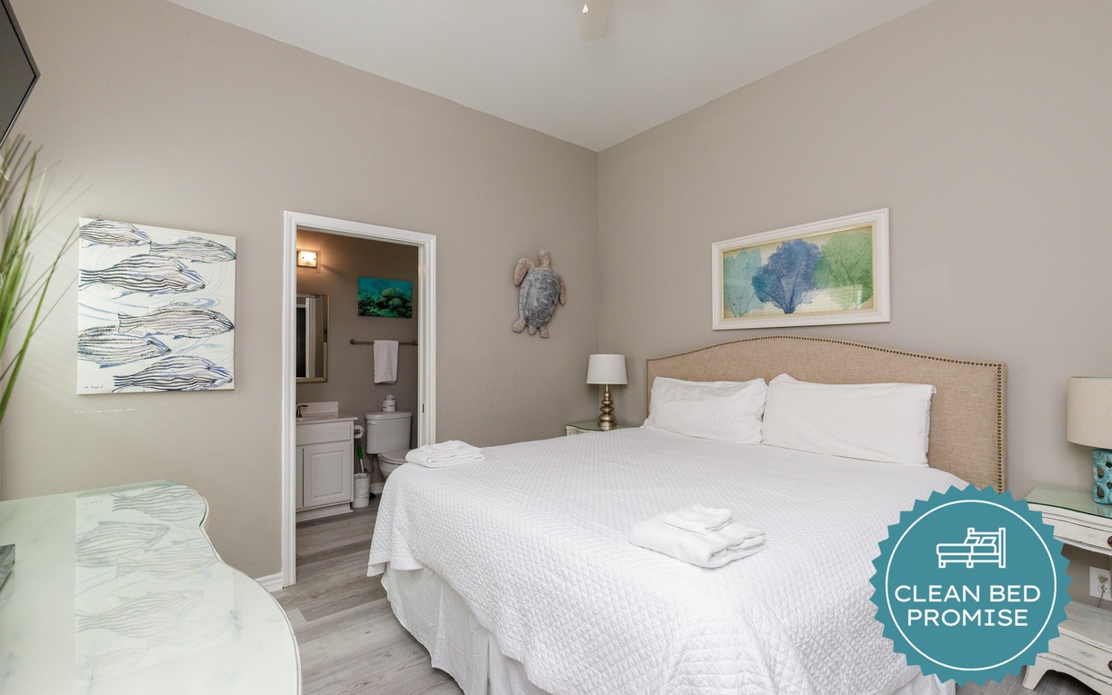 Slip into crisp linens in your serene coastal retreat, where ocean-themed art and soft blues create the perfect seaside sanctuary for restful nights.