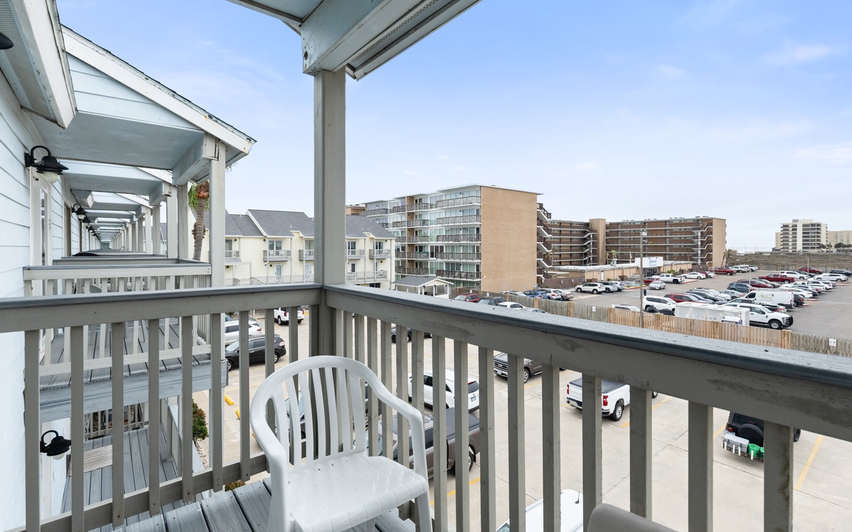 Step onto your private balcony and enjoy fresh air with comfortable seating overlooking the bustling area below.