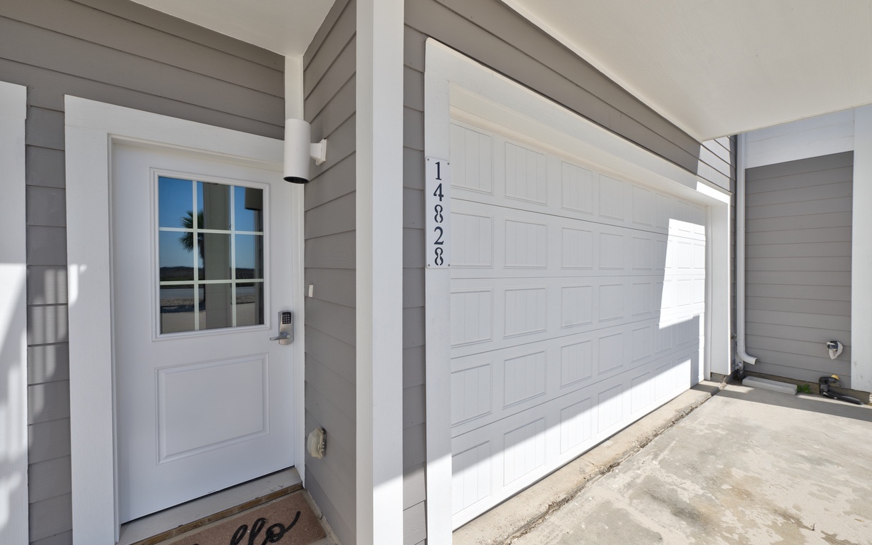Your welcoming entrance awaits with modern charm and convenient covered parking right at your doorstep.