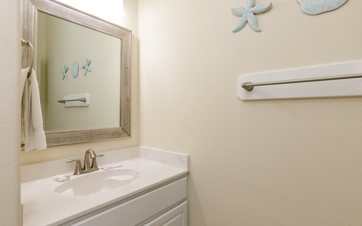 Your private bathroom features coastal charm with starfish décor, plus accessible grab bars for safety and comfort during your stay.