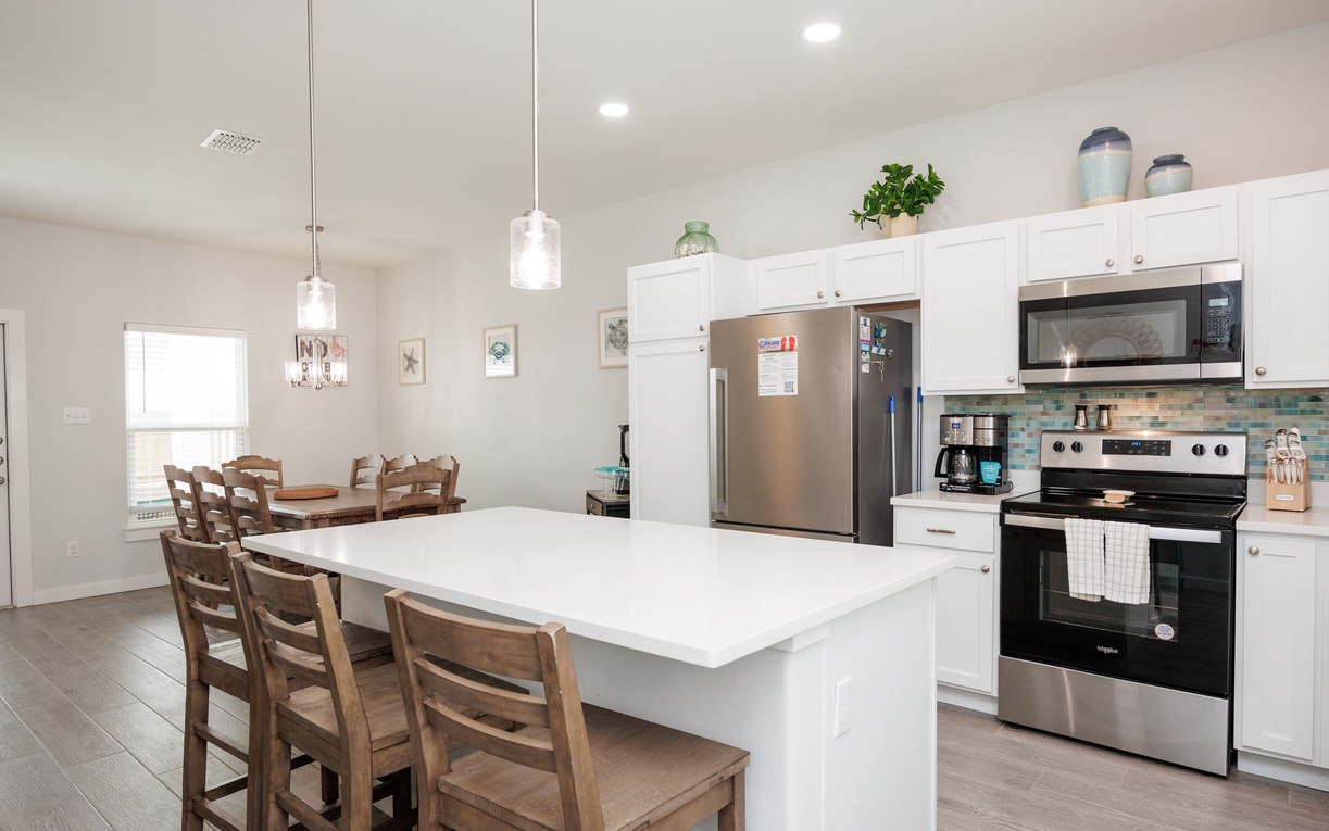 Your spacious kitchen features stainless steel appliances, a large island for meal prep, and bar seating perfect for morning coffee.