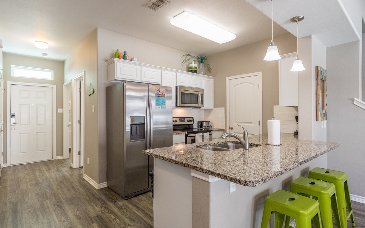 Your fully equipped kitchen features granite countertops, stainless steel appliances, and a breakfast bar where you can enjoy morning coffee together.