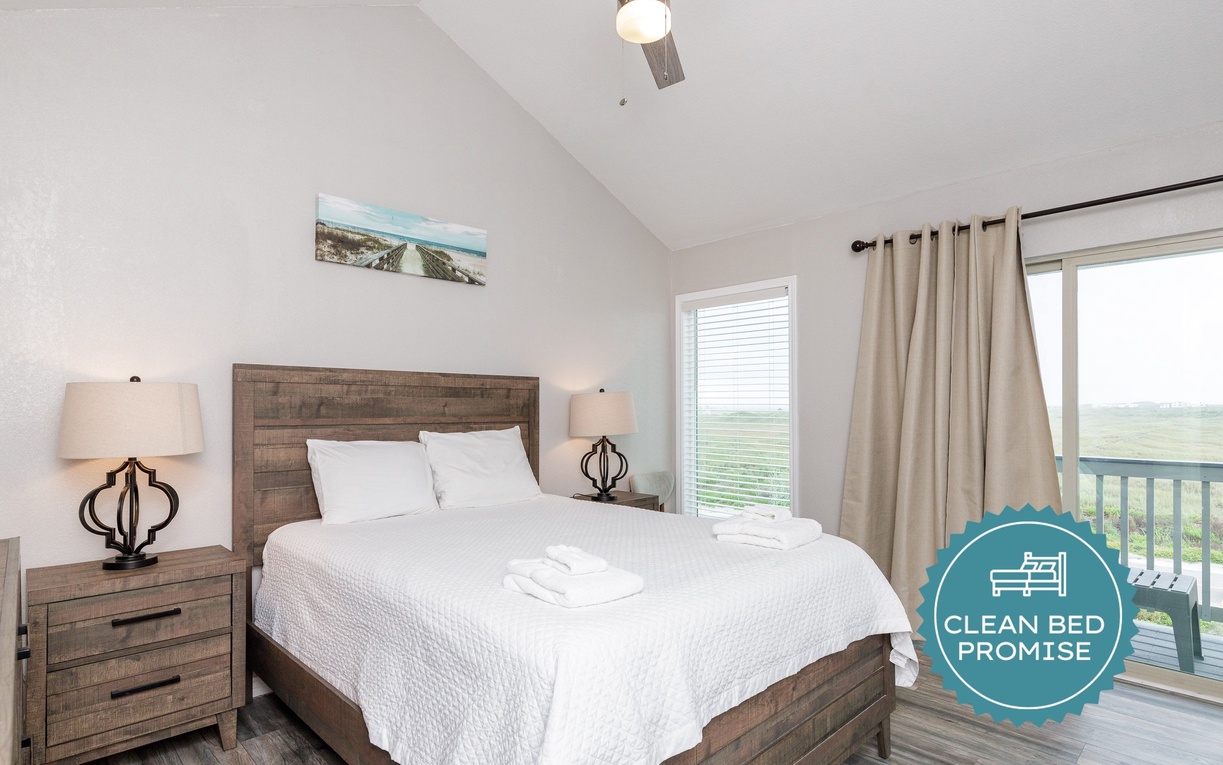 Sink into crisp white linens and wake to stunning views from your private balcony in this serene bedroom retreat.
