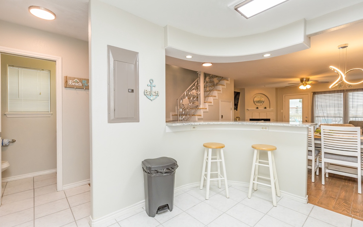 Gather around your breakfast bar with coastal charm, where beach-themed decor and an open layout create the perfect space for morning coffee and conversation.