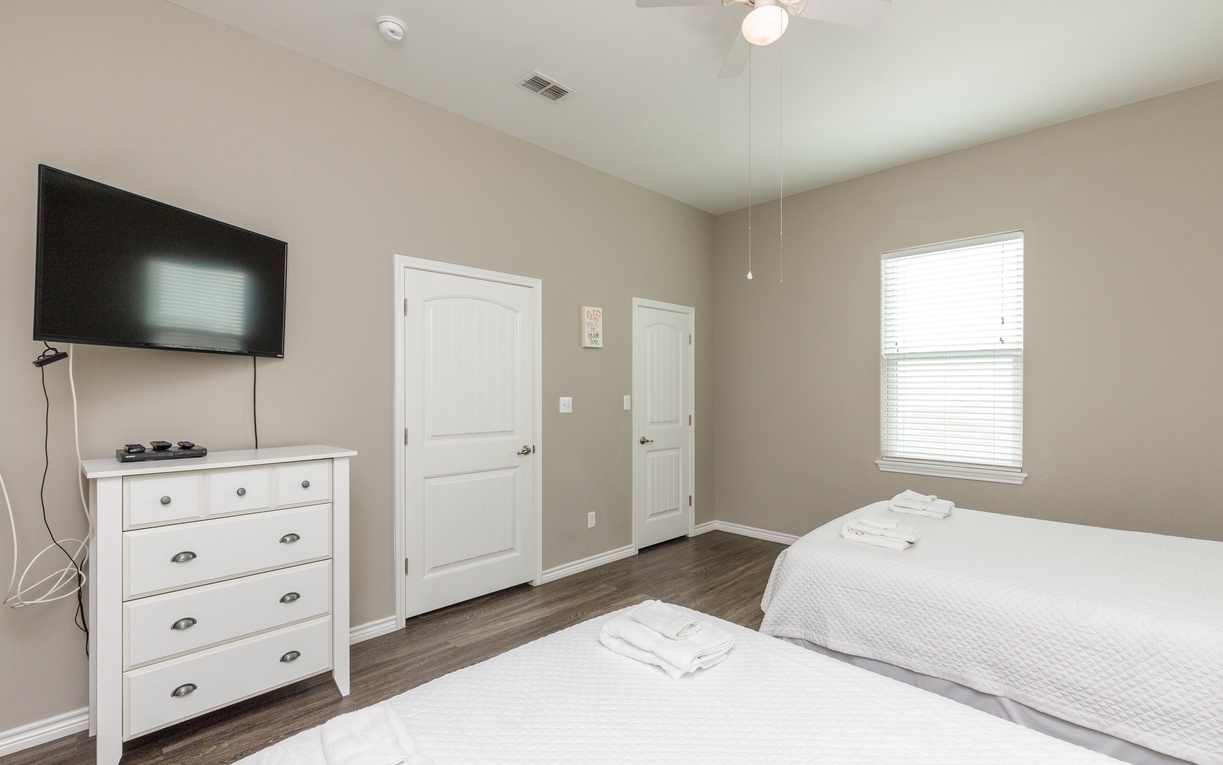 Unwind in your spacious bedroom with crisp linens, modern TV, and plenty of storage for your belongings.