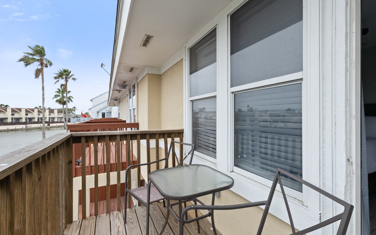 Step onto your private balcony and breathe in the coastal breeze while palm trees sway in the distance.