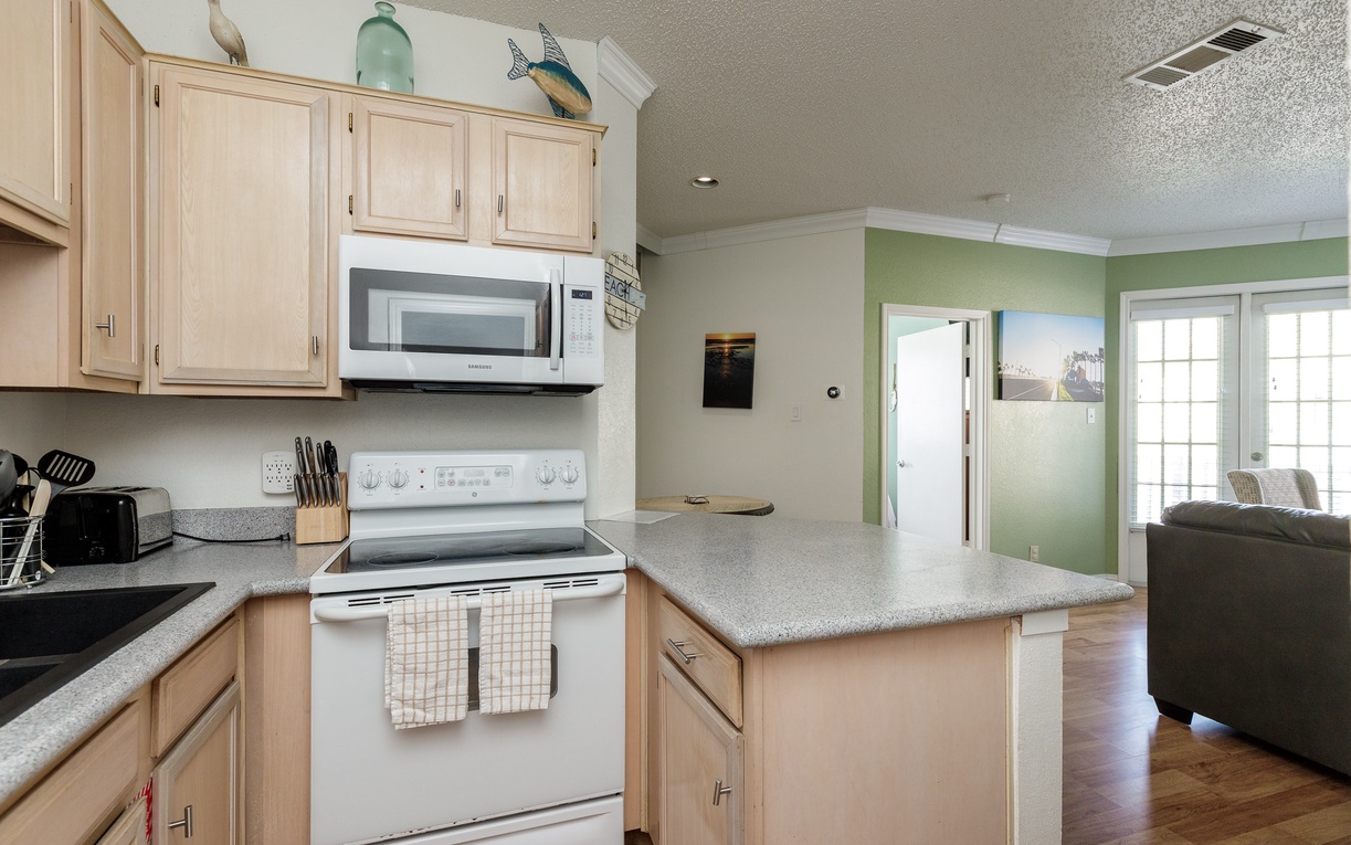 Your fully-equipped kitchen features granite countertops and opens to the bright living area—perfect for preparing meals and staying connected.