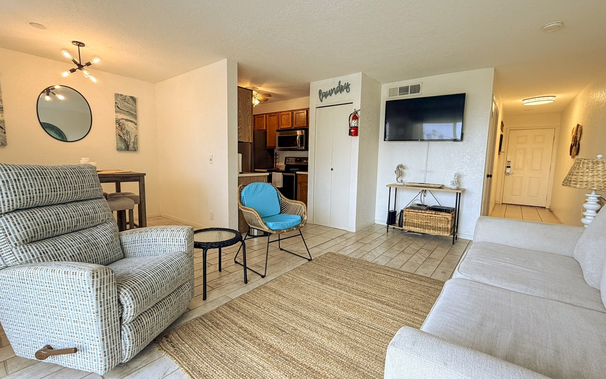 Relax in your thoughtfully furnished living space with comfy seating, modern kitchen access, and entertainment center ready for memorable evenings.