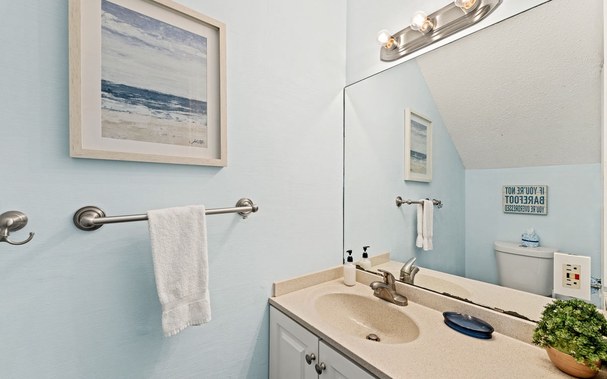Freshen up in your bright, beach-inspired bathroom with coastal artwork and soft lighting. Clean towels and thoughtful touches welcome you after a day of adventure.