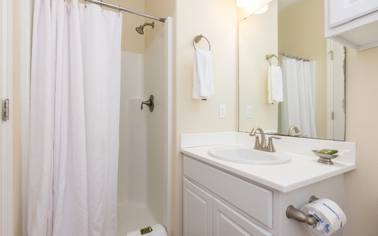 Step into your pristine private bathroom, complete with fresh towels and thoughtful amenities for your comfort.