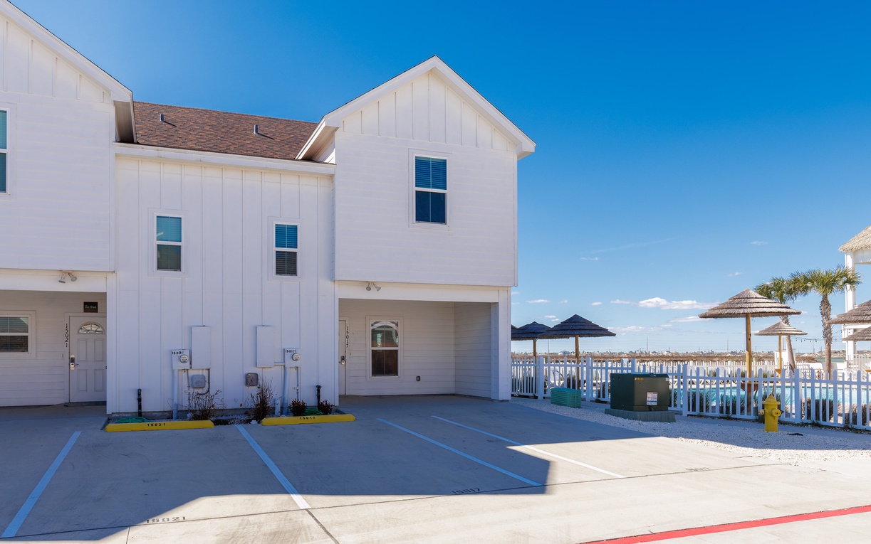 Modern coastal property with convenient parking and beach access amenities nearby.