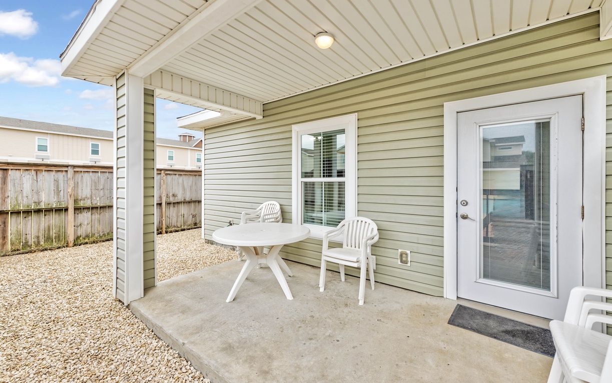 Your private covered patio offers the perfect spot for morning coffee or evening conversations, complete with comfortable seating and peaceful backyard views.