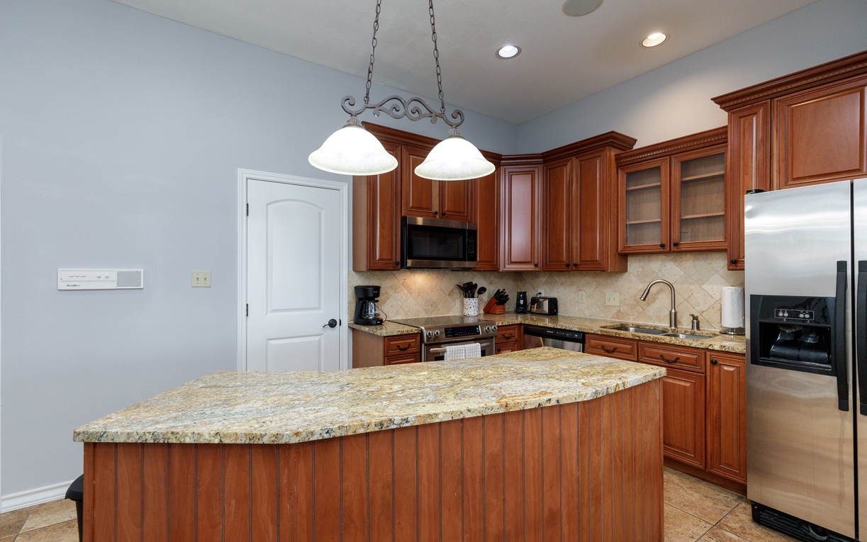 Your gourmet kitchen awaits with rich cherry cabinets, granite countertops, and stainless steel appliances - perfect for preparing memorable meals.